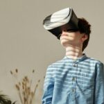 A young boy wearing VR goggles, exploring virtual reality in a cozy living room.